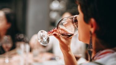 A woman drinking a glass of wine