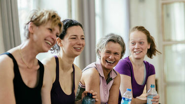 Group of women at the gym laughing