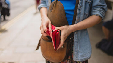 A women looking into an empty wallet