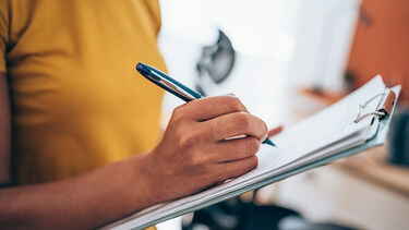 A woman writing on a piece of paper