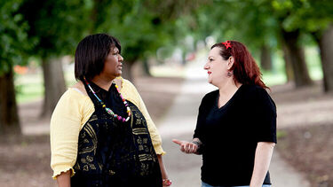 Two women talking in a park